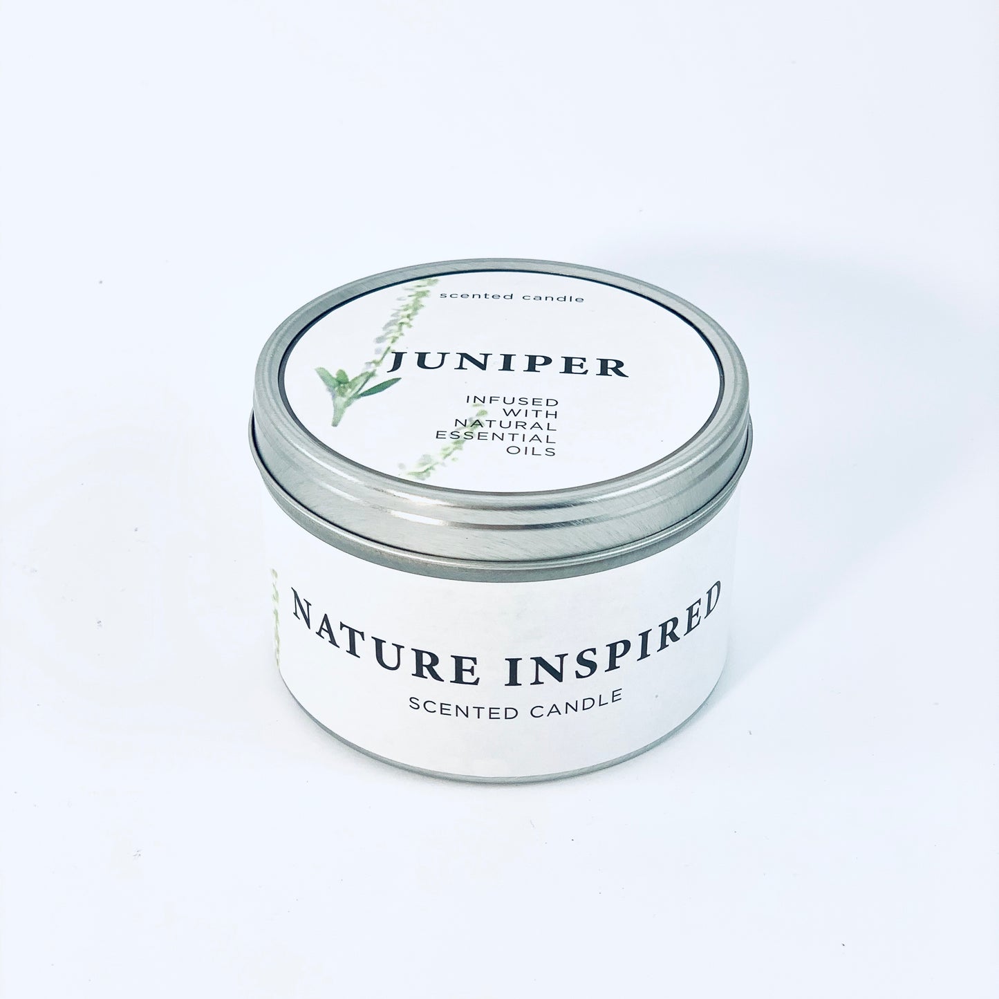 Natural soy wax candle in a metal container with juniper scent