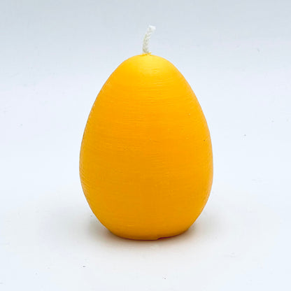 Design candle Easter egg from soy wax, yellow
